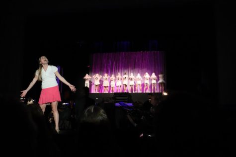 Junior Kate Gleeson-Feldman, playing the lead role of Elle Woods, belts out a note during a live performance of the schools spring production Legally Blonde. 