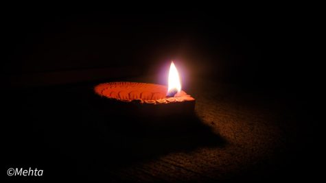 A diya (flame) is lit in honor of Diwali, a widely celebrated holiday in Indian cultures. Photo taken by Arnav Mehta. 