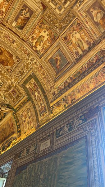 The intricately detailed ceiling of the  Sistine Chapel, a world-known tourist attraction located in the Vatican, shines. 
