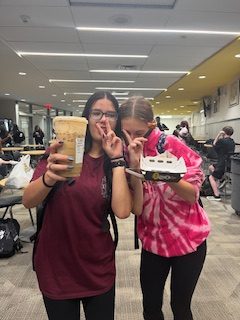 Nadiya Castro and Hope Jones posing with their pumpkin cream chai latte from Starbucks.